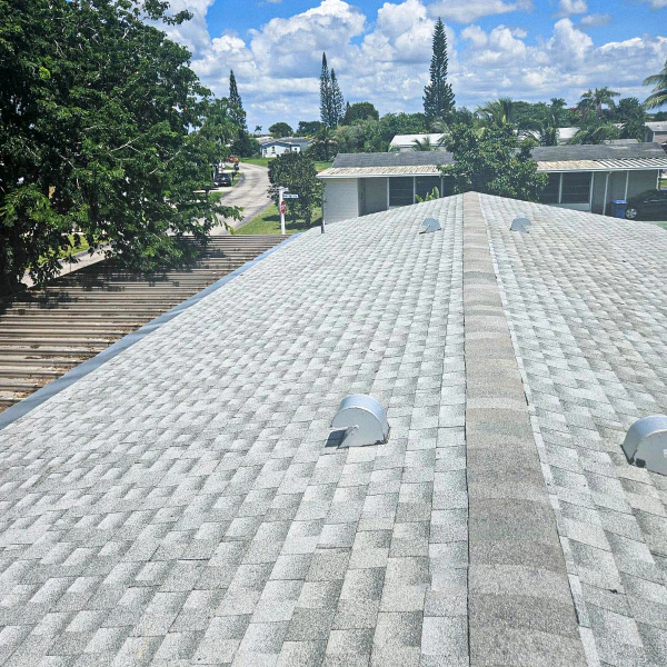 residential roof with newly installed light color shingle
